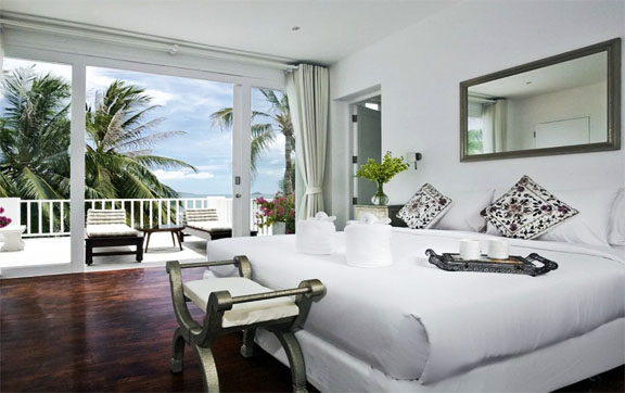 One of the five bedrooms at Villa M, Koh Samui, showing the beatuiful views of the ocean that can be seen from the balcony.